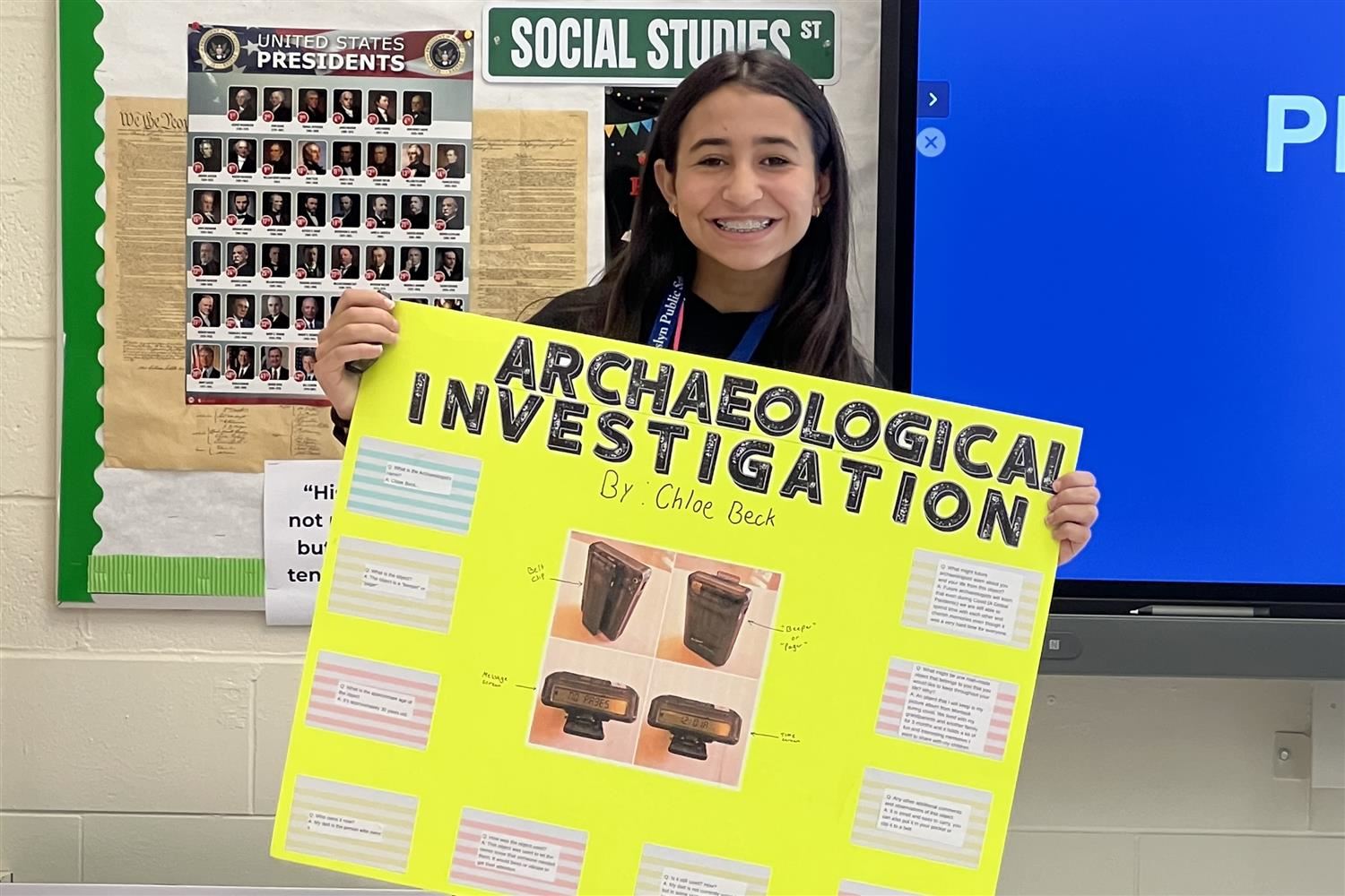  student holding poster